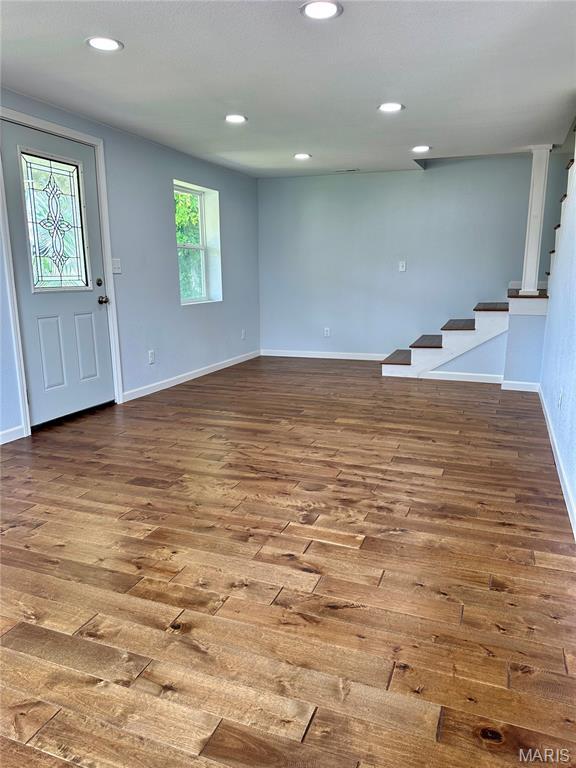 401 Clara St, Potosi, MO 63664 - unfurnished living room with stairway, wood finished floors, and recessed lighting