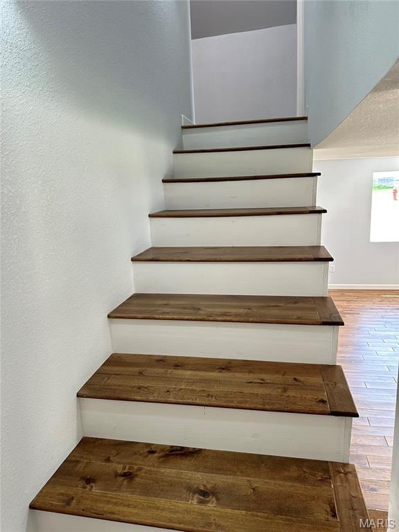 401 Clara St, Potosi, MO 63664 - staircase with wood finished floors and a textured wall