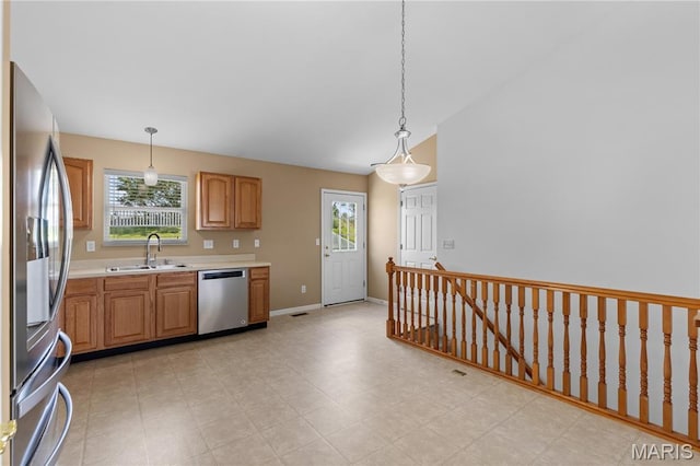 925 Stone Crossing Dr, Wentzville, MO 63385 - kitchen with appliances with stainless steel finishes, light countertops, healthy amount of natural light, and decorative light fixtures