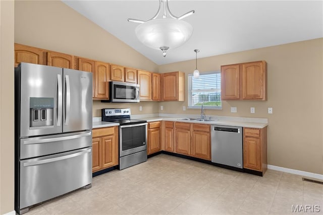 925 Stone Crossing Dr, Wentzville, MO 63385 - kitchen with appliances with stainless steel finishes, lofted ceiling, light countertops, and hanging light fixtures