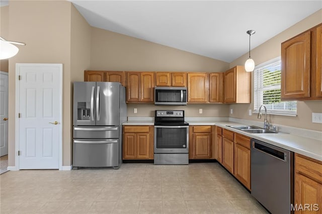 925 Stone Crossing Dr, Wentzville, MO 63385 - kitchen featuring appliances with stainless steel finishes, vaulted ceiling, light countertops, and hanging light fixtures