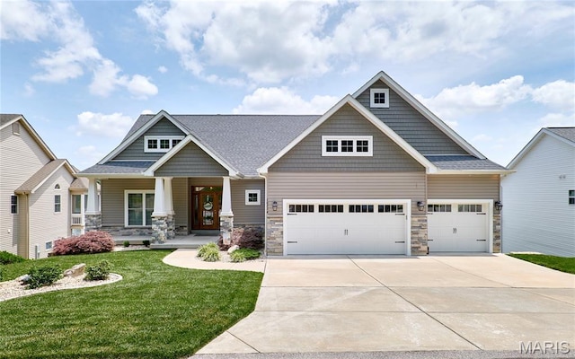 10234 Village Dr, Foristell, MO 63348 - craftsman inspired home with a garage, concrete driveway, a front lawn, covered porch, and stone siding