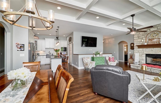 10234 Village Dr, Foristell, MO 63348 - dining space with arched walkways, ceiling fan, dark wood finished floors, recessed lighting, and coffered ceiling