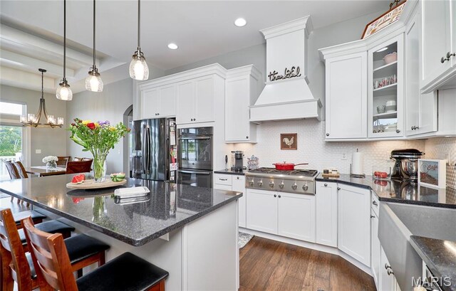 10234 Village Dr, Foristell, MO 63348 - kitchen with appliances with stainless steel finishes, white cabinets, recessed lighting, glass insert cabinets, and dark wood-style floors