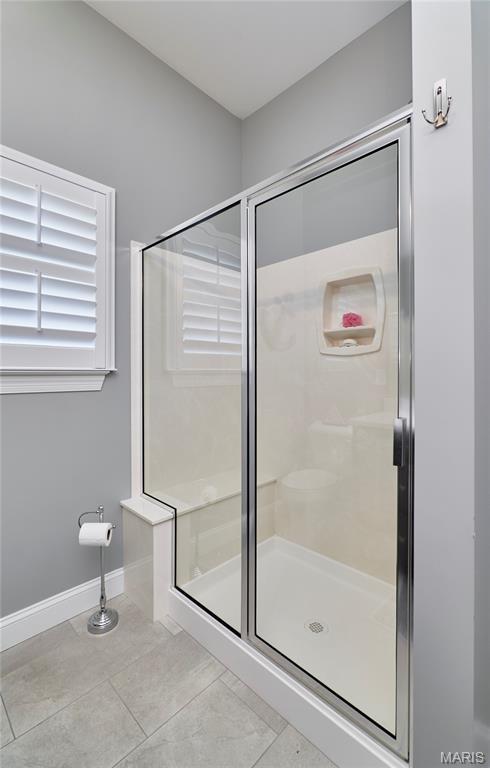 10234 Village Dr, Foristell, MO 63348 - full bathroom featuring a shower stall and tile patterned floors