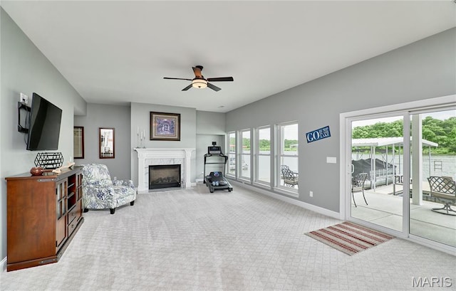 10234 Village Dr, Foristell, MO 63348 - living area featuring carpet flooring, a premium fireplace, and ceiling fan