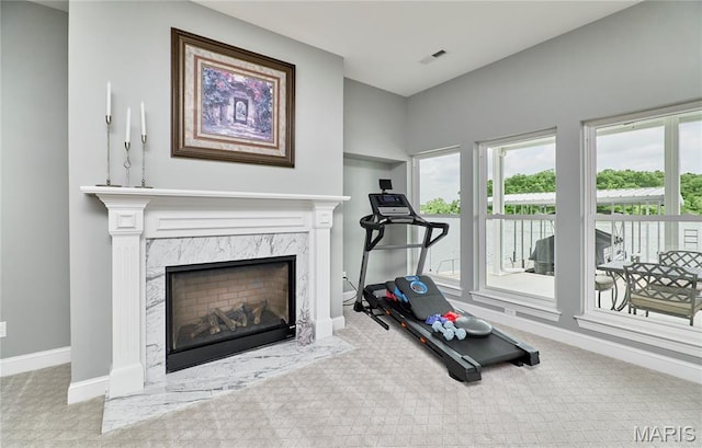 10234 Village Dr, Foristell, MO 63348 - workout room with a high end fireplace and carpet