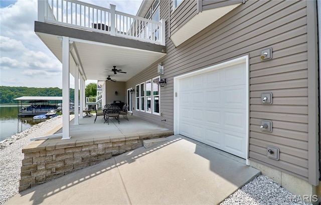 10234 Village Dr, Foristell, MO 63348 - patio / terrace with a water view, a ceiling fan, and a garage