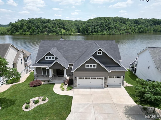 10234 Village Dr, Foristell, MO 63348 - craftsman inspired home featuring stone siding, concrete driveway, and a water view