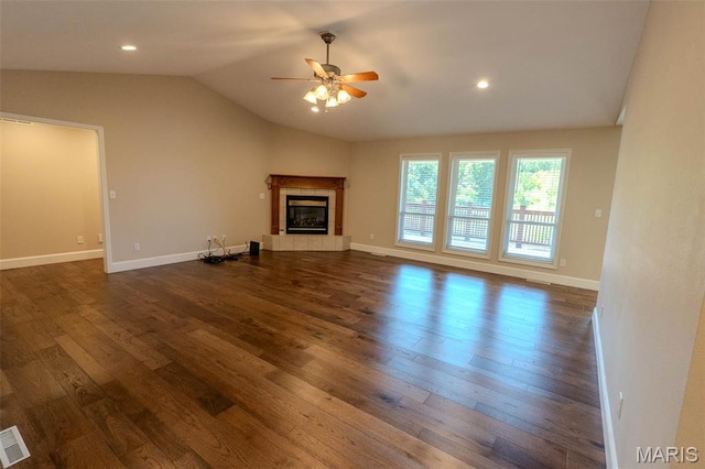 11782 Pine Forest Dr, Rolla, MO 65401 - unfurnished living room with a ceiling fan, vaulted ceiling, dark wood finished floors, a tiled fireplace, and recessed lighting