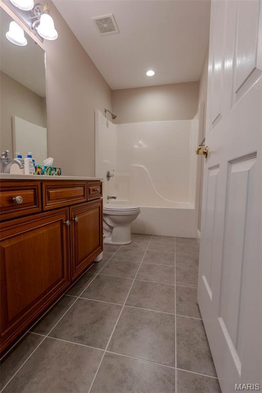 11782 Pine Forest Dr, Rolla, MO 65401 - full bath featuring vanity, shower / bathtub combination, tile patterned flooring, and recessed lighting