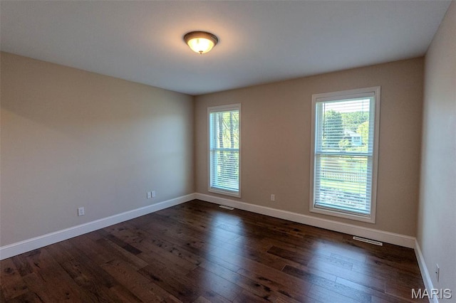 11782 Pine Forest Dr, Rolla, MO 65401 - spare room with healthy amount of natural light and dark wood-style floors