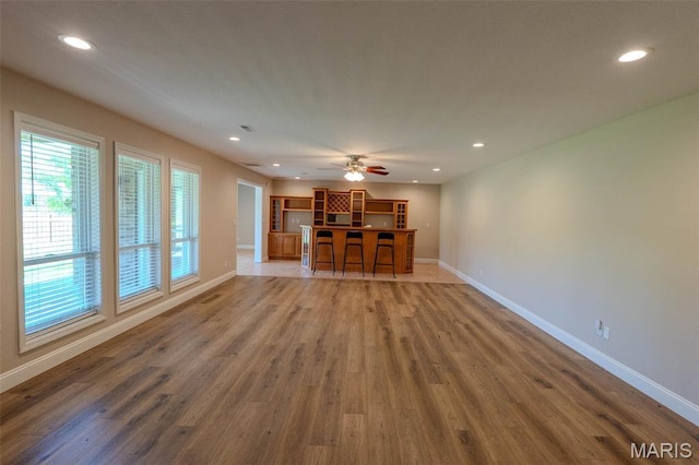 11782 Pine Forest Dr, Rolla, MO 65401 - unfurnished living room featuring wood finished floors, recessed lighting, and ceiling fan
