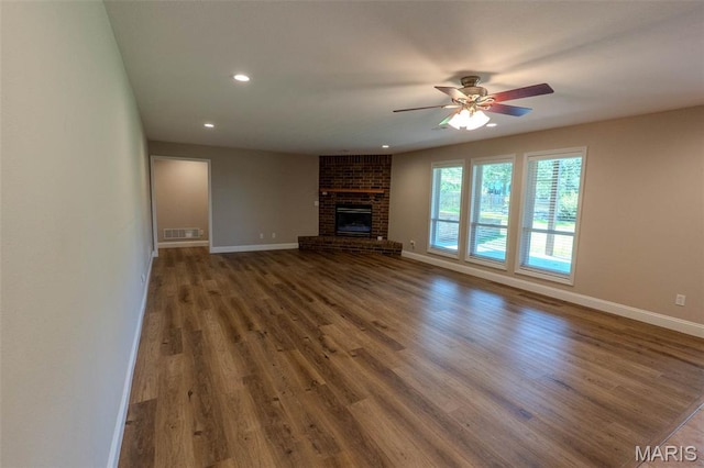 11782 Pine Forest Dr, Rolla, MO 65401 - unfurnished living room with wood finished floors, ceiling fan, recessed lighting, and a brick fireplace