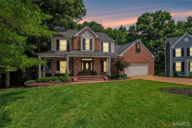 742 Arbor Ridge Ct, Ballwin, MO 63021 - traditional home featuring concrete driveway, covered porch, a yard, an attached garage, and brick siding