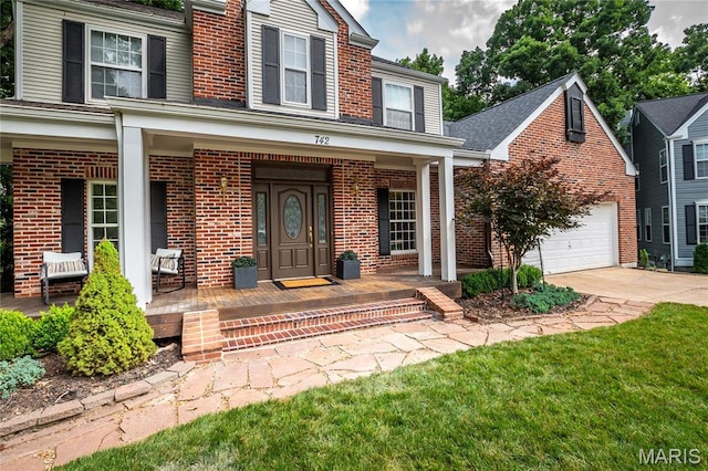 742 Arbor Ridge Ct, Ballwin, MO 63021 - view of front of property featuring a porch, brick siding, driveway, and a garage