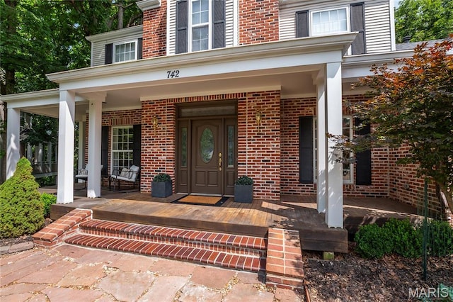 742 Arbor Ridge Ct, Ballwin, MO 63021 - view of exterior entry with a porch and brick siding