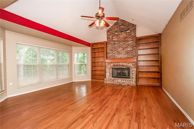 742 Arbor Ridge Ct, Ballwin, MO 63021 - unfurnished living room with ceiling fan, lofted ceiling, built in shelves, wood finished floors, and a brick fireplace