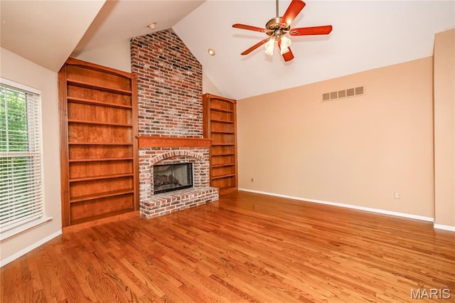 742 Arbor Ridge Ct, Ballwin, MO 63021 - unfurnished living room featuring vaulted ceiling, a brick fireplace, wood finished floors, a ceiling fan, and built in features