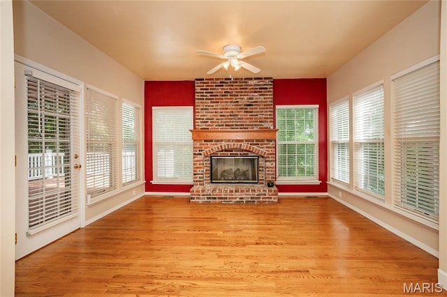 742 Arbor Ridge Ct, Ballwin, MO 63021 - unfurnished living room featuring a ceiling fan, wood finished floors, plenty of natural light, and a fireplace