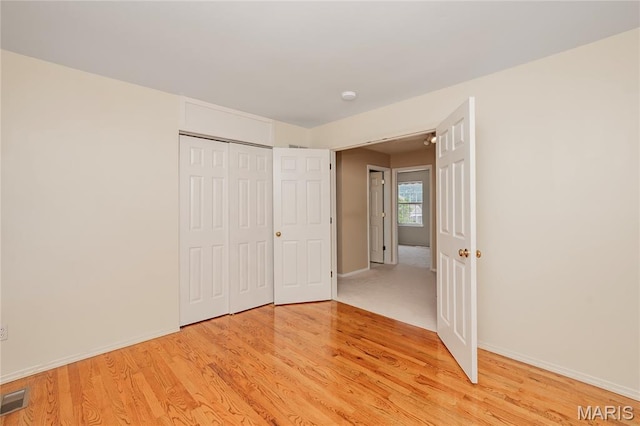 742 Arbor Ridge Ct, Ballwin, MO 63021 - unfurnished bedroom with light wood-type flooring and a closet