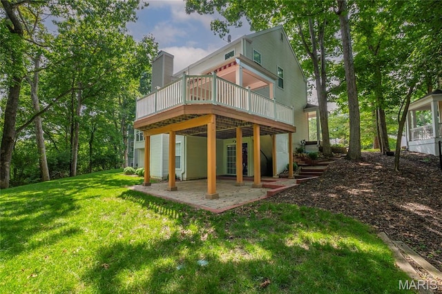 742 Arbor Ridge Ct, Ballwin, MO 63021 - back of house featuring a patio, a wooden deck, a lawn, and a chimney