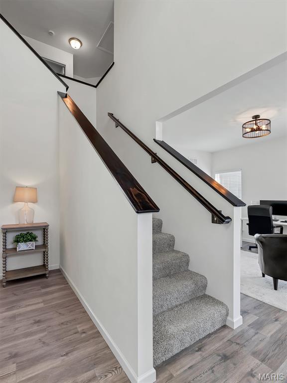 1673 Lake Meade Dr, Pacific, MO 63069 - stairway featuring wood finished floors and a chandelier