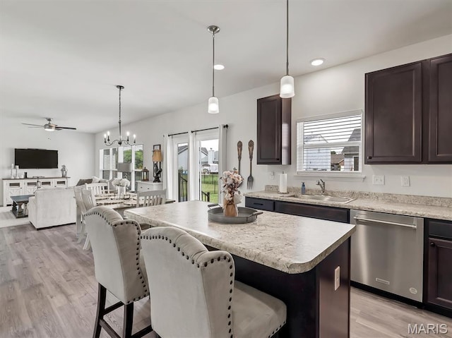 1673 Lake Meade Dr, Pacific, MO 63069 - kitchen with dishwasher, dark brown cabinets, a kitchen breakfast bar, a center island, and healthy amount of natural light