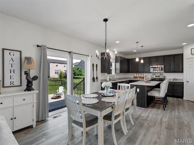 1673 Lake Meade Dr, Pacific, MO 63069 - dining room featuring light wood-type flooring, recessed lighting, and a chandelier