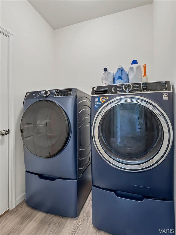 1673 Lake Meade Dr, Pacific, MO 63069 - laundry area with separate washer and dryer and light wood-type flooring