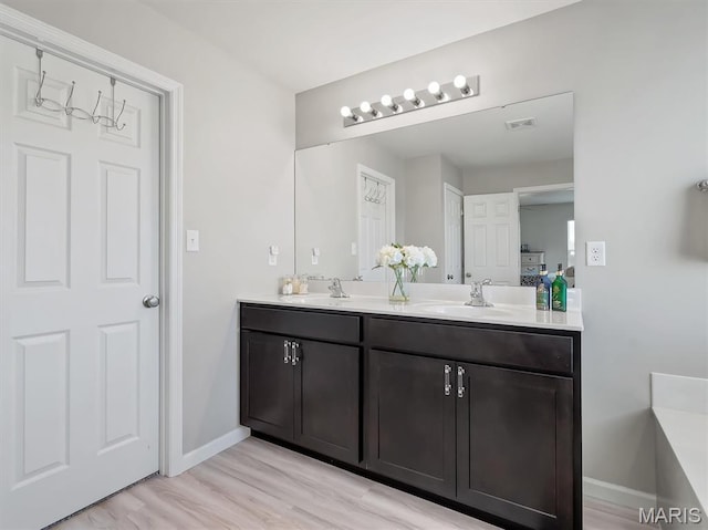 1673 Lake Meade Dr, Pacific, MO 63069 - bathroom featuring double vanity and wood finished floors