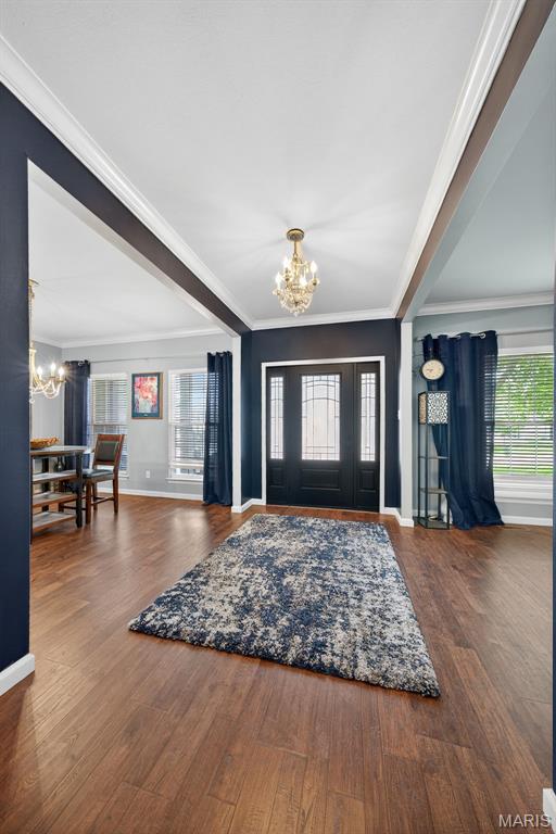 10 Renaud Pass, Ofallon, MO 63366 - foyer entrance featuring a chandelier, crown molding, healthy amount of natural light, and wood finished floors