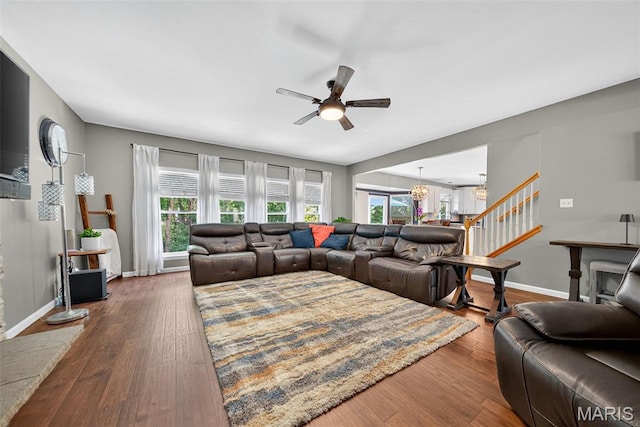 10 Renaud Pass, Ofallon, MO 63366 - living area featuring a ceiling fan, dark wood-type flooring, and stairs