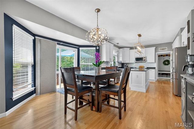 10 Renaud Pass, Ofallon, MO 63366 - dining space with a chandelier and light wood-style flooring