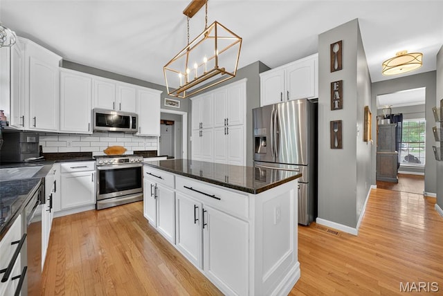 10 Renaud Pass, Ofallon, MO 63366 - kitchen featuring appliances with stainless steel finishes, white cabinetry, and light wood-type flooring