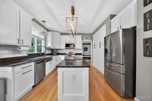 10 Renaud Pass, Ofallon, MO 63366 - kitchen featuring appliances with stainless steel finishes, white cabinetry, and decorative backsplash