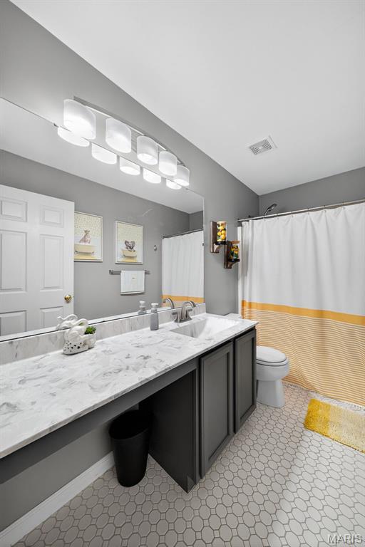 10 Renaud Pass, Ofallon, MO 63366 - full bath with vanity, tile patterned floors, and a shower with shower curtain