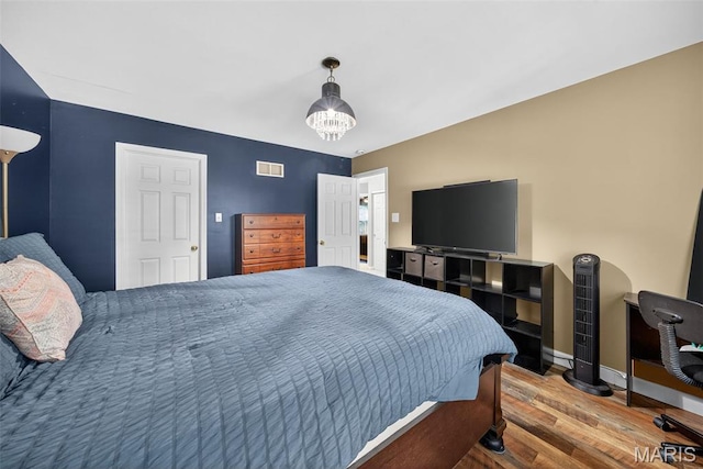 10 Renaud Pass, Ofallon, MO 63366 - bedroom featuring wood finished floors and a chandelier
