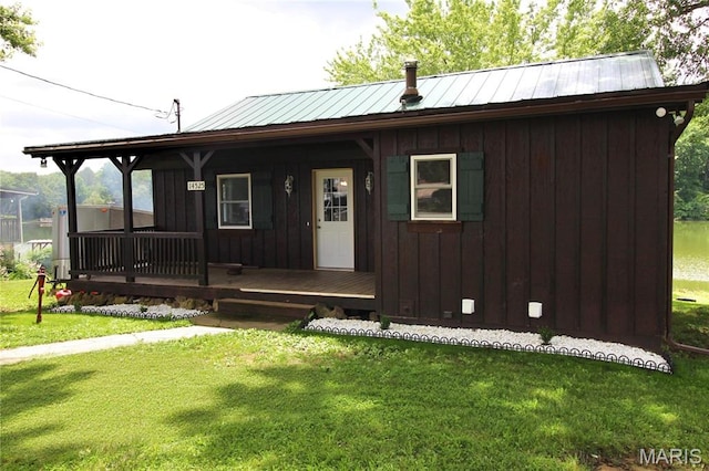 14525 Meadowlark Ln, Saint Genevieve, MO 63670 - view of front of property featuring covered porch, a front lawn, a metal roof, and board and batten siding
