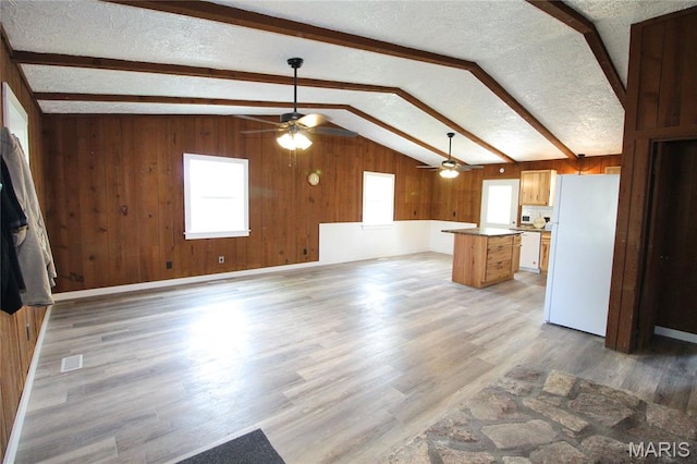 14525 Meadowlark Ln, Saint Genevieve, MO 63670 - unfurnished living room featuring ceiling fan, wooden walls, plenty of natural light, light wood-style floors, and a textured ceiling