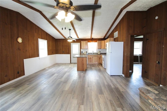 14525 Meadowlark Ln, Saint Genevieve, MO 63670 - kitchen with freestanding refrigerator, wood walls, ceiling fan, wood finished floors, and a textured ceiling