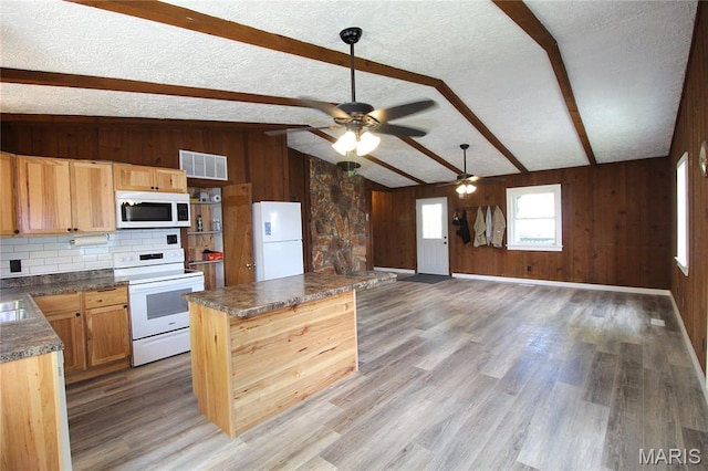 14525 Meadowlark Ln, Saint Genevieve, MO 63670 - kitchen with white appliances, wood walls, a ceiling fan, dark countertops, and light wood-type flooring