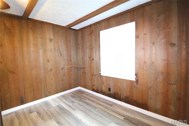 14525 Meadowlark Ln, Saint Genevieve, MO 63670 - spare room with wood walls, wood finished floors, and beamed ceiling