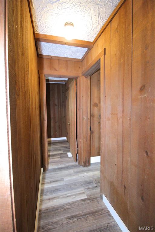 14525 Meadowlark Ln, Saint Genevieve, MO 63670 - hallway with wood walls and wood finished floors