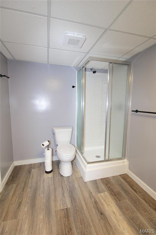 14525 Meadowlark Ln, Saint Genevieve, MO 63670 - bathroom with a drop ceiling, a stall shower, and wood finished floors