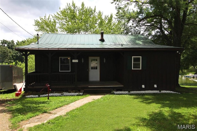 14525 Meadowlark Ln, Saint Genevieve, MO 63670 - view of front of home with covered porch, a standing seam roof, a front lawn, a metal roof, and board and batten siding