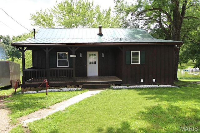 14525 Meadowlark Ln, Saint Genevieve, MO 63670 - view of front of property with a porch, a front lawn, board and batten siding, and a standing seam roof