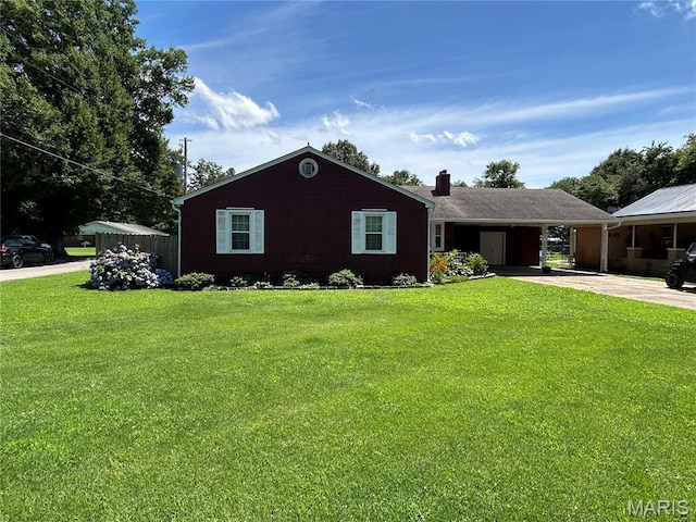 301 W Clipper St, Kennett, MO 63857 - ranch-style house featuring driveway, a chimney, an attached carport, and a front lawn