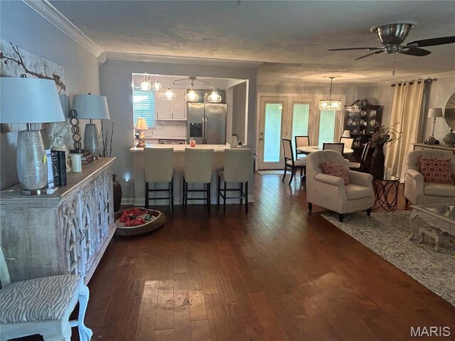 301 W Clipper St, Kennett, MO 63857 - living room with dark wood finished floors, a ceiling fan, a chandelier, and crown molding