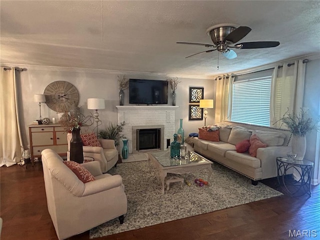 301 W Clipper St, Kennett, MO 63857 - living area featuring a ceiling fan, a fireplace, wood finished floors, a textured ceiling, and ornamental molding